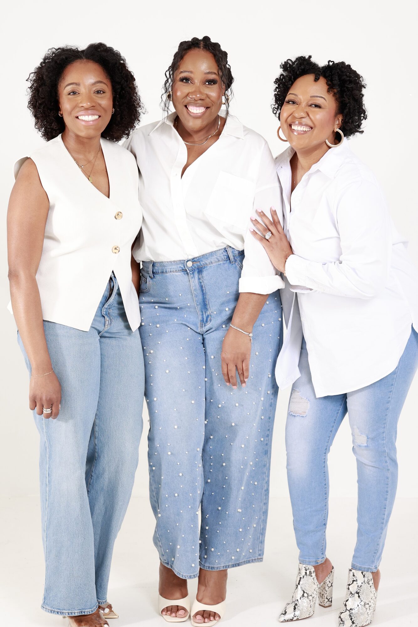 Three women of BLOOM standing together, smiling