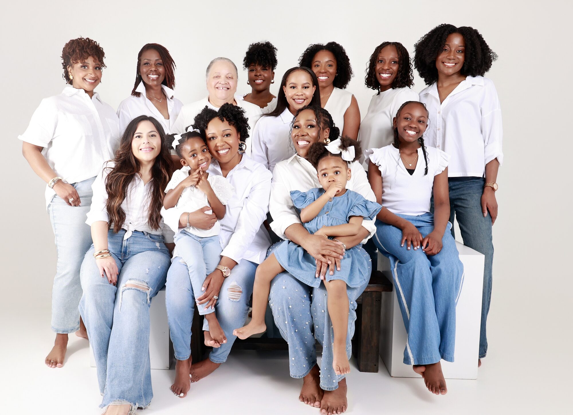 The BLOOM community together across generations, women, elders and children gathered for a group portrait